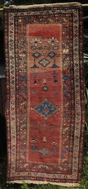 Kurdish rug with humans, animals, blossoms - opens jpg in same window
